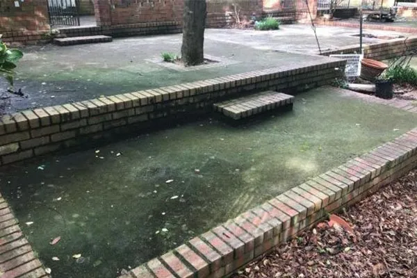 Stained residential driveway before pressure washing