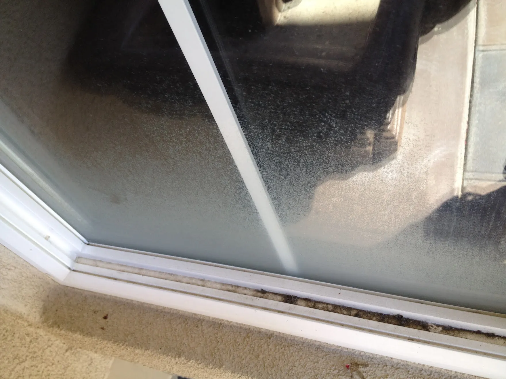 Hard water stain buildup on window glass before professional removal in Temecula Valley